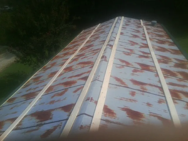 Rusted metal roof panels with new wood purlins before replacement — Storm Damage Roof Repair in Saint Inigoes by Roofing Brothers